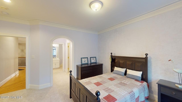 bedroom featuring baseboards, arched walkways, light carpet, and ornamental molding