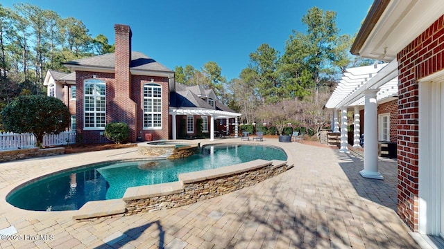 view of pool with fence, a patio area, a pergola, and a pool with connected hot tub