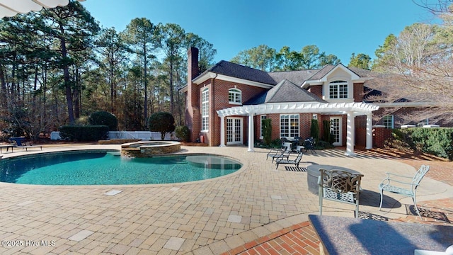 view of pool with a pool with connected hot tub, french doors, a pergola, and a patio