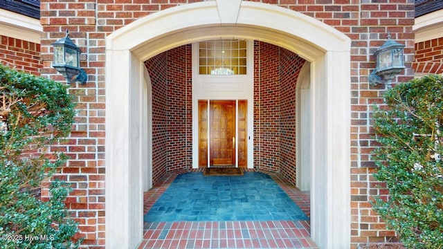 property entrance featuring brick siding