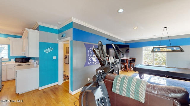 interior space featuring recessed lighting, baseboards, light wood-style floors, and ornamental molding