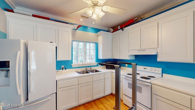 kitchen with white appliances, ceiling fan, a sink, white cabinets, and under cabinet range hood