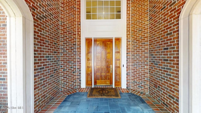 property entrance featuring brick siding