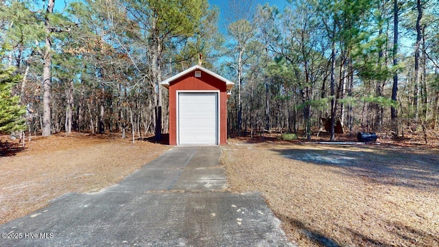 view of outbuilding with an outbuilding and a forest view