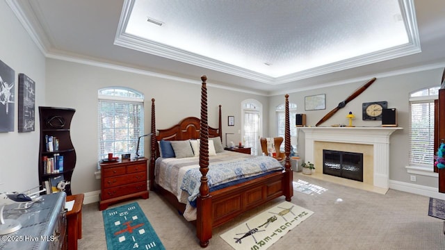 bedroom with visible vents, multiple windows, light colored carpet, and crown molding