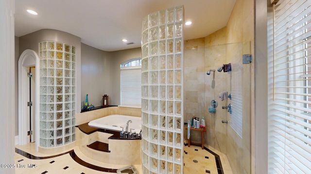 full bathroom featuring recessed lighting, walk in shower, and a bath