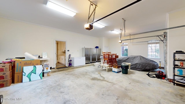 garage with fridge and a garage door opener