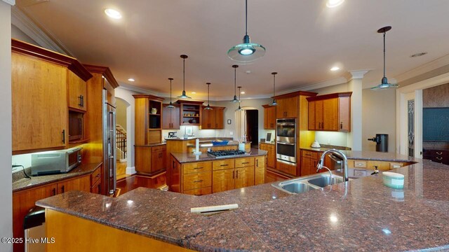 kitchen featuring open shelves, arched walkways, a large island with sink, stainless steel appliances, and a sink