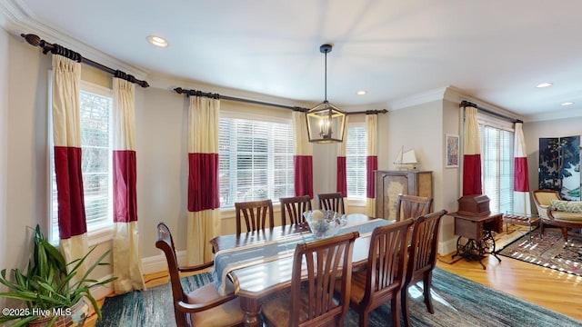 dining space with recessed lighting, baseboards, wood finished floors, and ornamental molding