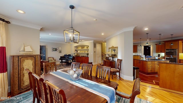 dining area with crown molding, light wood-style flooring, recessed lighting, and baseboards