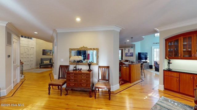 hall with visible vents, baseboards, recessed lighting, light wood-style floors, and crown molding