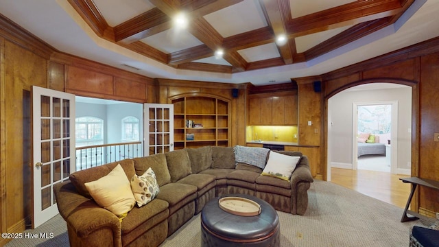 living room featuring beam ceiling, a wealth of natural light, and coffered ceiling