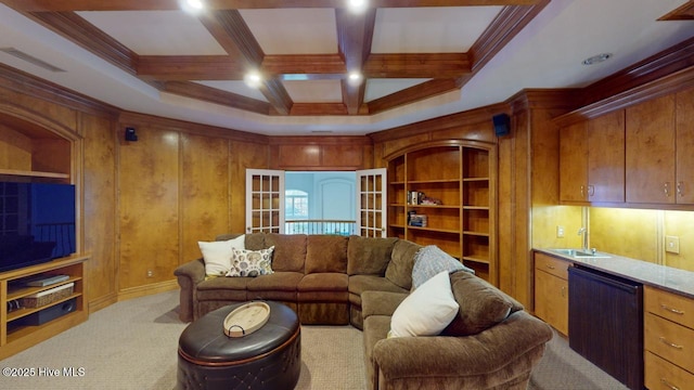 carpeted living room with beamed ceiling, ornamental molding, indoor wet bar, coffered ceiling, and a sink