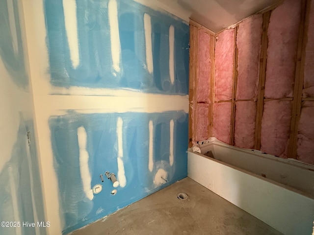 full bath featuring unfinished concrete floors and a bath