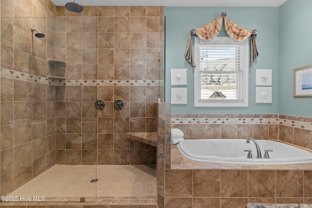 bathroom with a bath and tiled shower