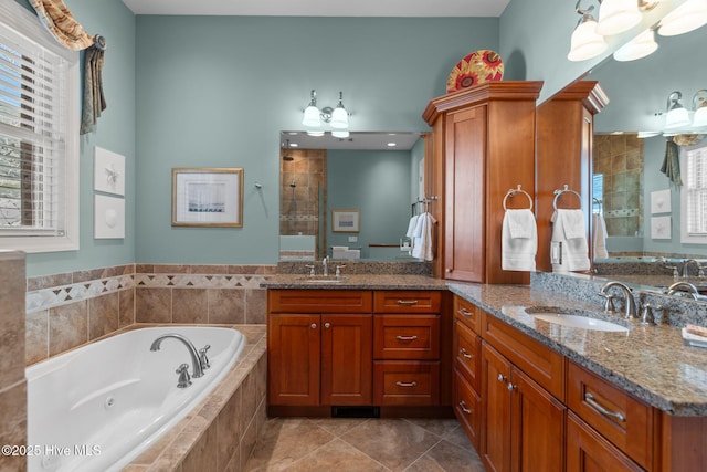 full bath featuring a sink, a whirlpool tub, and a tile shower
