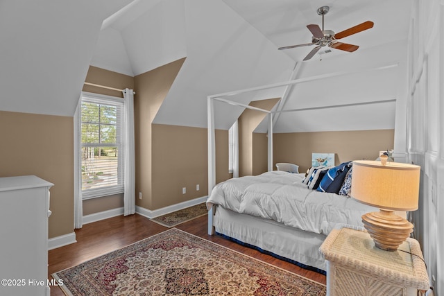 bedroom featuring ceiling fan, baseboards, lofted ceiling, and wood finished floors