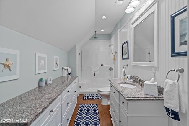 6790 Waterstone Xing SW, Ocean Isle Beach, NC 28469 - bathroom featuring vanity, walk in shower, wood finished floors, vaulted ceiling, and recessed lighting