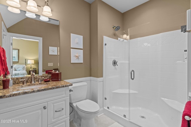 6790 Waterstone Xing SW, Ocean Isle Beach, NC 28469 - ensuite bathroom featuring a shower stall, vanity, and a wainscoted wall
