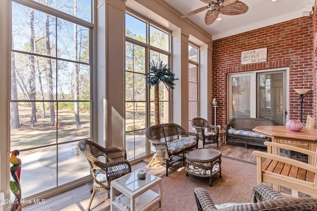 sunroom with an outdoor living space and a ceiling fan