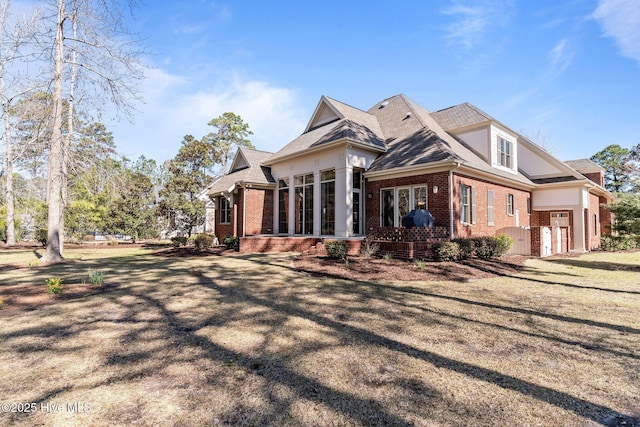 back of house featuring brick siding