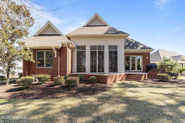 view of front of house with brick siding and a front yard