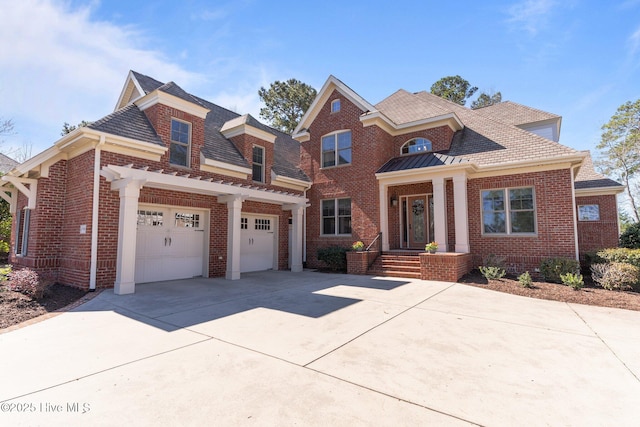 view of front of house with concrete driveway and brick siding