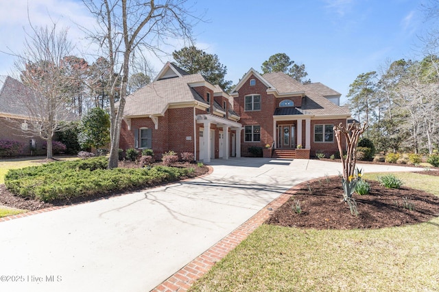 view of front facade with brick siding and concrete driveway