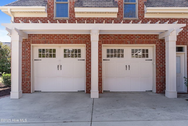 garage featuring concrete driveway