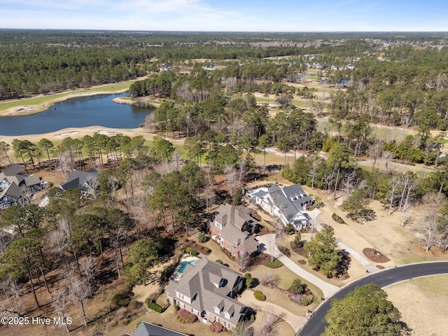 drone / aerial view with a water view and a wooded view