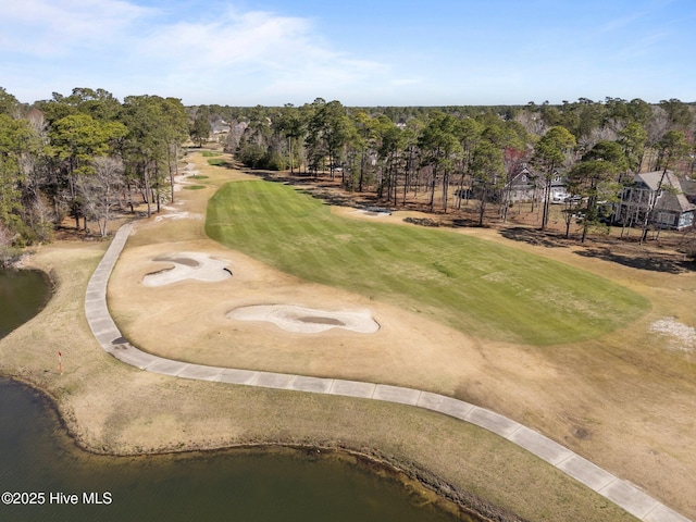 drone / aerial view with a water view and view of golf course