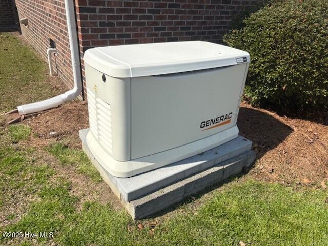 exterior details featuring brick siding and a power unit