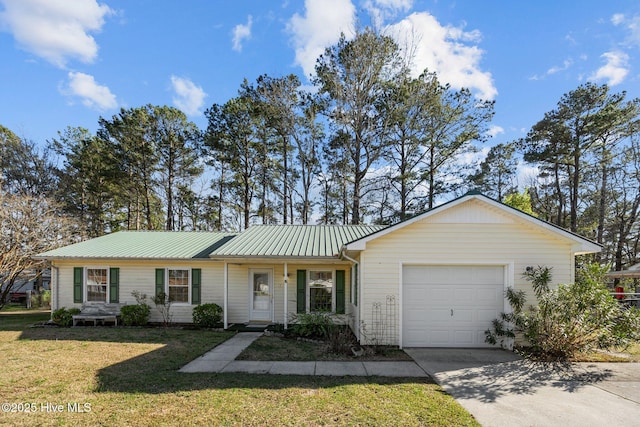 ranch-style home with driveway, metal roof, a garage, and a front yard