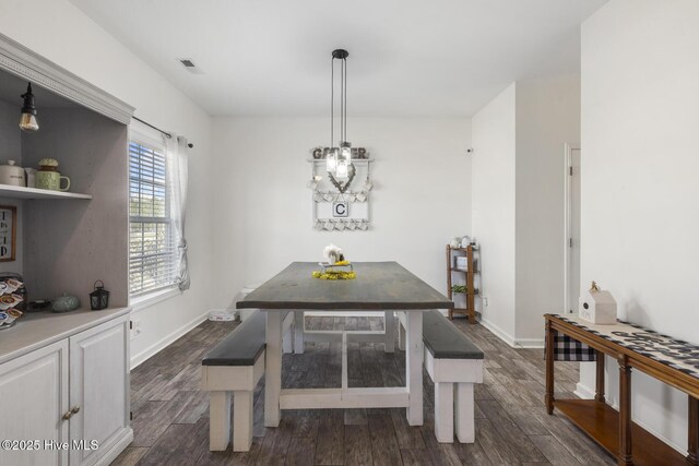 dining room featuring visible vents, baseboards, and dark wood-style flooring