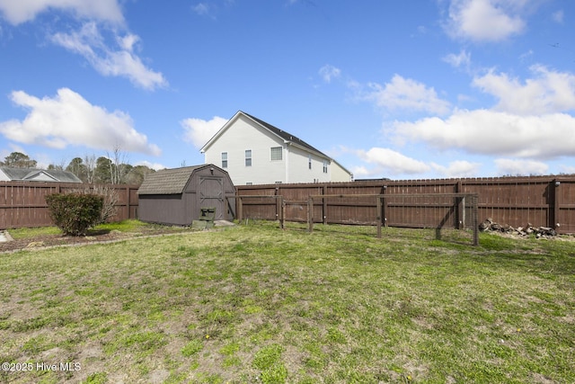 view of yard featuring an outbuilding, a storage unit, and a fenced backyard