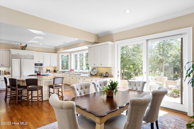 dining area featuring ornamental molding, wood finished floors, and recessed lighting