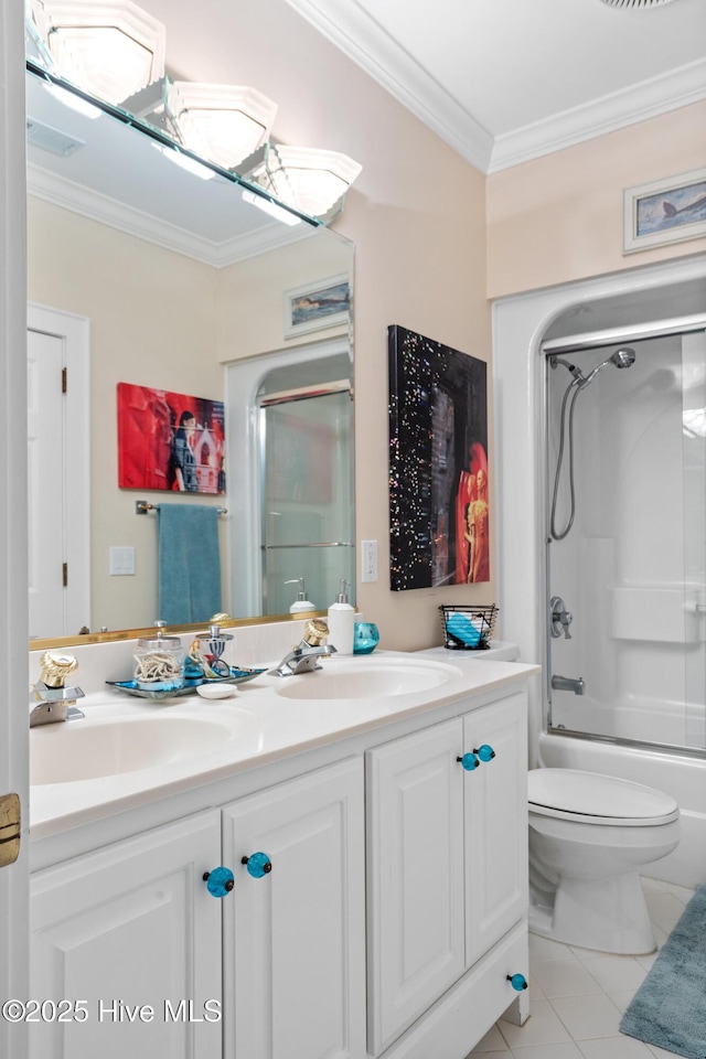 bathroom featuring double vanity, tile patterned floors, crown molding, and a sink