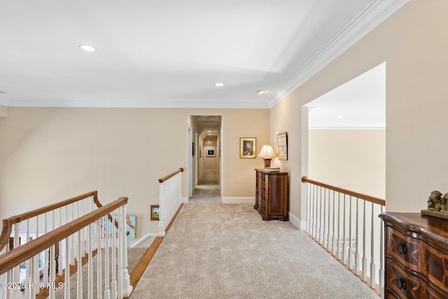 hallway with crown molding, an upstairs landing, carpet floors, baseboards, and recessed lighting