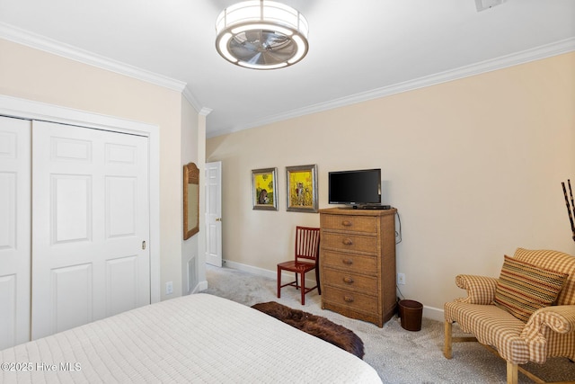 bedroom featuring carpet, a closet, crown molding, and baseboards