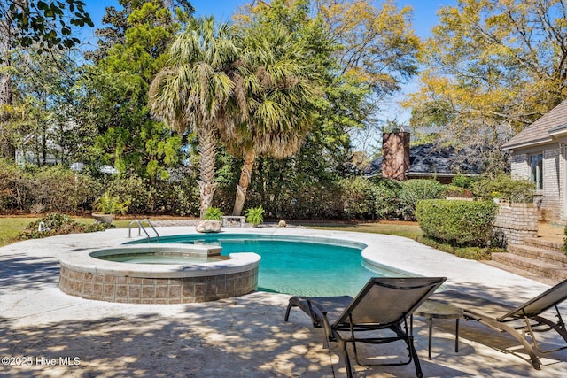 view of pool with a patio and a pool with connected hot tub