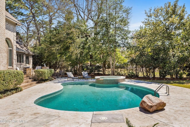 view of swimming pool featuring a patio area and a pool with connected hot tub