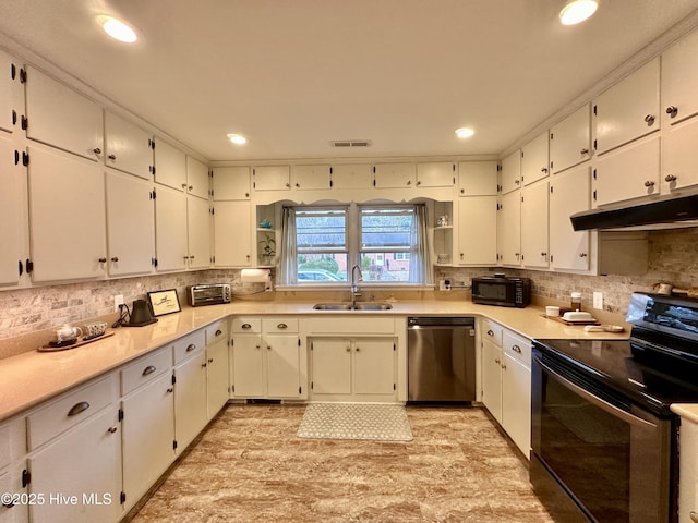 kitchen featuring tasteful backsplash, a sink, under cabinet range hood, and black appliances