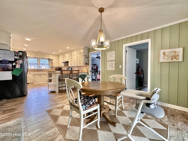 dining room with ceiling fan and ornamental molding