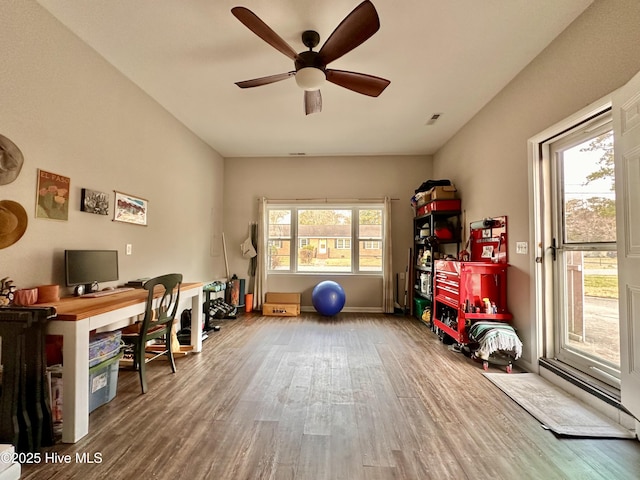 office space featuring visible vents, baseboards, a ceiling fan, and wood finished floors
