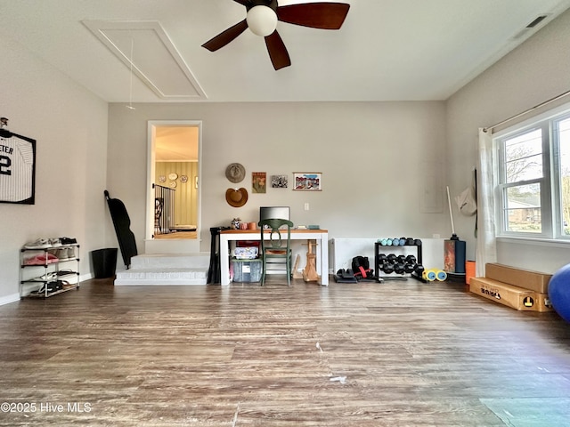 office area featuring attic access, a ceiling fan, wood finished floors, and visible vents