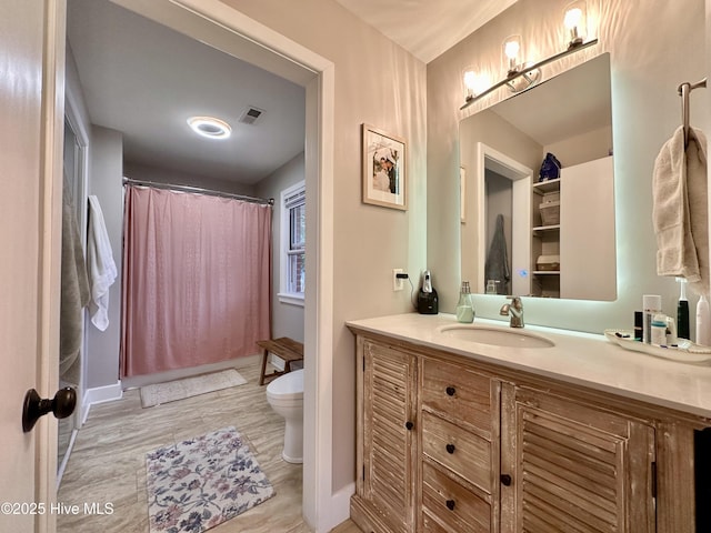 bathroom featuring toilet, baseboards, visible vents, a shower with shower curtain, and vanity