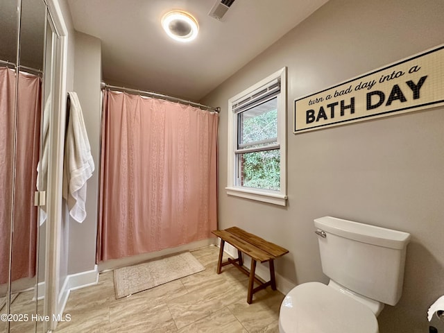 bathroom featuring baseboards, visible vents, a shower with shower curtain, and toilet