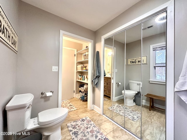 bathroom featuring toilet, tile patterned flooring, and visible vents