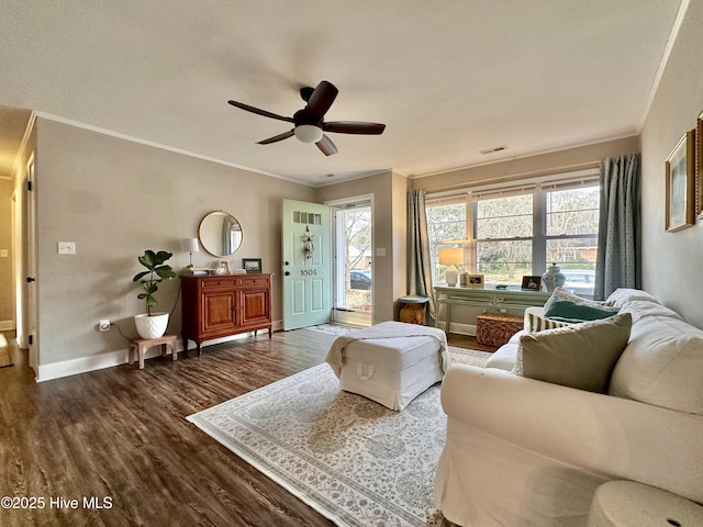 living area featuring baseboards, a ceiling fan, dark wood-style floors, and crown molding