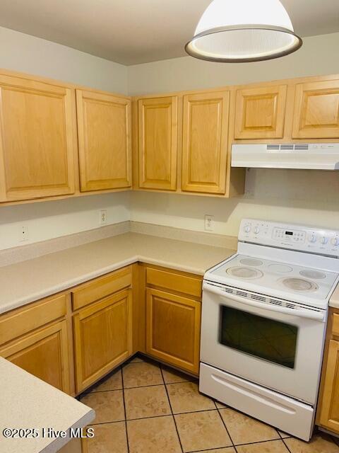 305 Comanche Trl, Havelock, NC 28532 - kitchen featuring electric stove, under cabinet range hood, light tile patterned flooring, light countertops, and light brown cabinetry